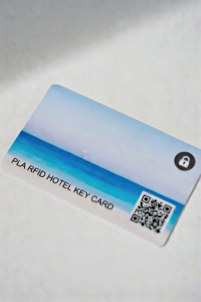 Side-by-side comparison of traditional PVC hotel key card and eco-friendly PLA biodegradable RFID hotel key card by okiismart
